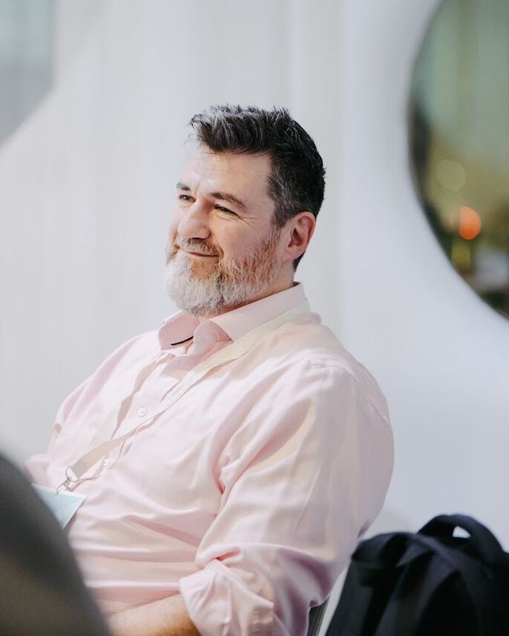 Tony Wood, smiling and listening during a leadership conversation