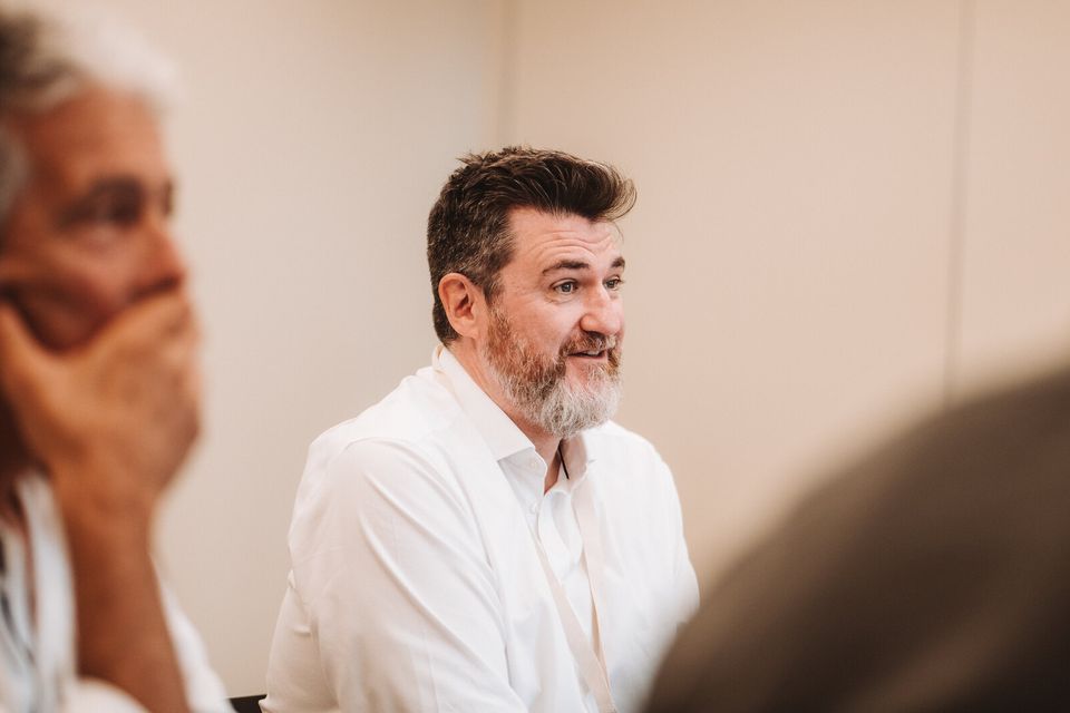 Tony Wood listening during a roundtable conversation with leaders
